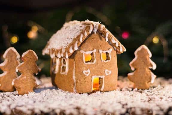 Gingerbread house and gingerbread trees on icing snow